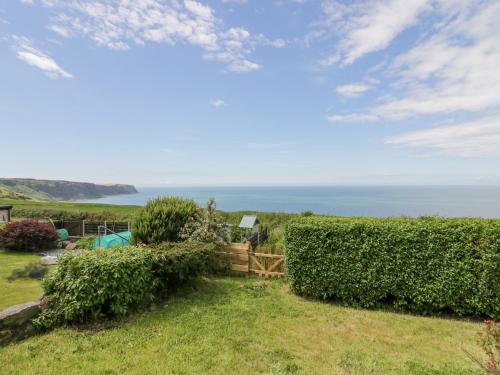 a garden with a view of the ocean at Victroneen Cottage in Whitehaven