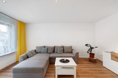 a living room with a couch and a table at Ferienwohnung Käshammer in Kappelrodeck
