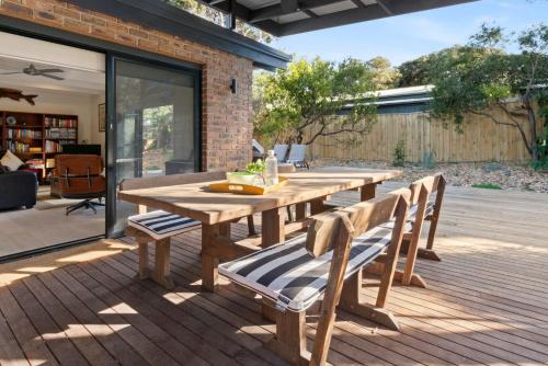 a wooden table and chairs on a deck at Brooks by the bay in Blairgowrie