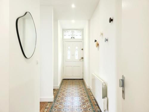 a hallway with a mirror and a door at Le Jardin d'Eden in Ay-sur-Moselle