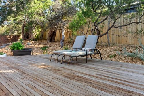 a pair of chairs sitting on a wooden deck at Brooks by the bay in Blairgowrie