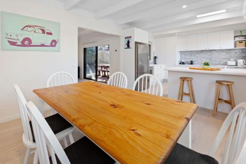 a kitchen and dining room with a wooden table and chairs at Brooks by the bay in Blairgowrie