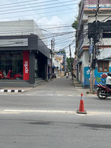 a orange traffic cone sitting in the middle of a street at Raj Andar Guest House in Agartala
