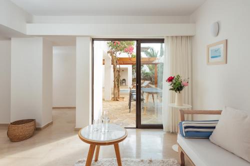 a living room with a couch and a table at St. Nicolas Bay Resort Hotel & Villas in Agios Nikolaos