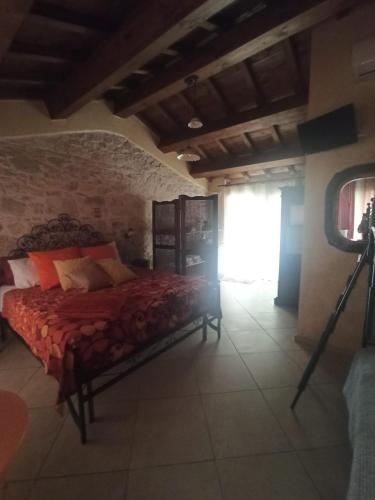 a bedroom with a bed with a camera on a tripod at La Cascina della Vachina in Poggio Bustone