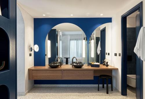 a bathroom with two sinks and a large mirror at Amyth of Mykonos Super Paradise in Super Paradise Beach