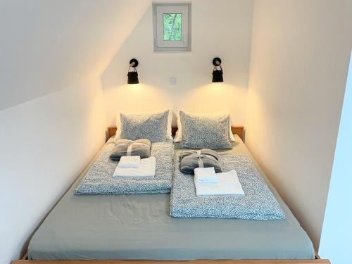 a bedroom with a bed with two pillows at Quiet, green, relaxing place - 1 bedroom apartment in Balatonfüred