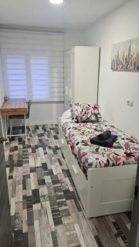 a bedroom with a bed and a table and a desk at Apartamento Soria Calaverón in Soria