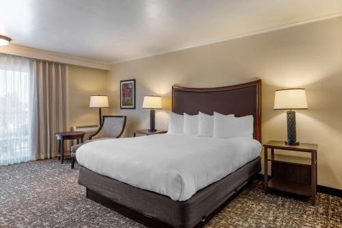 a hotel room with a large bed and two lamps at Best Western Plus Royal Oak Hotel in San Luis Obispo