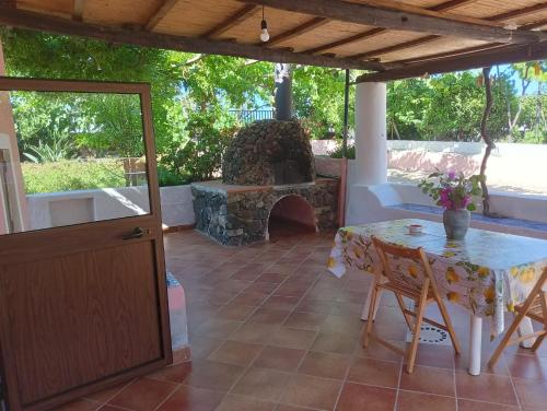 a patio with a table and a stone oven at A casa Di Fabrizio Appartamento Il Forno in Filicudi