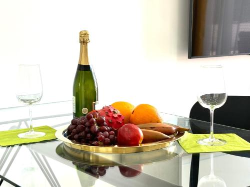 a bowl of fruit on a table with a bottle of wine at Casa Francisca 100 mt from the beach By lucaproperties in Puerto Rico de Gran Canaria