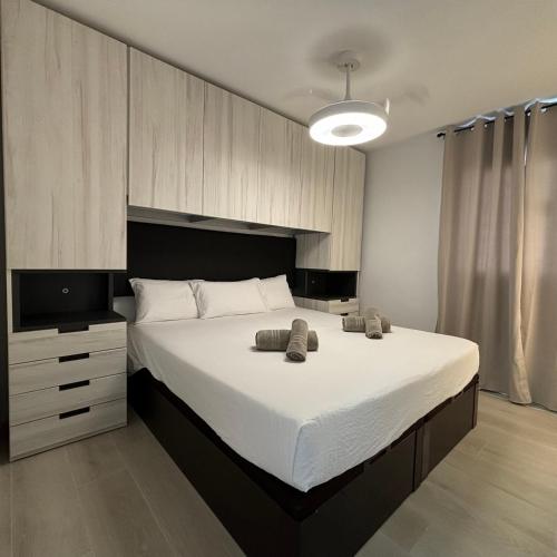 a bedroom with a large bed with two towels on it at Casa Francisca 100 mt from the beach By lucaproperties in Puerto Rico de Gran Canaria