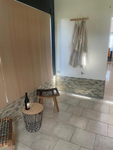 a room with a table and a bottle of wine at Kuća za odmor Mariola in Karlovac