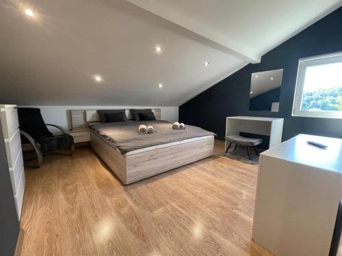 a bedroom with a large bed and a window at Kuća za odmor Mariola in Karlovac