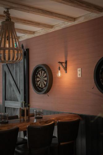 a dining room with a dart board on the wall at Hotel Groede in Groede