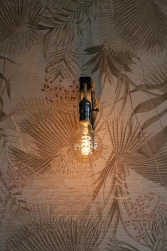a light fixture hanging from a wall at Hotel Groede in Groede