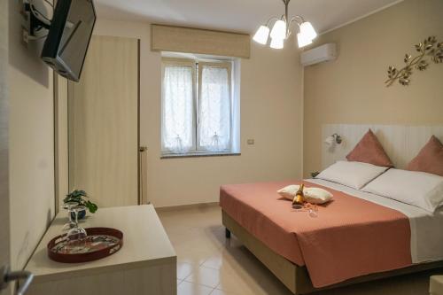 a hotel room with a bed and a television at Nonna Carmela Holiday House in San Lazzaro Agerola