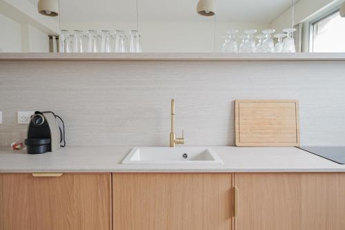 une cuisine avec un évier et un plan de travail dans l'établissement Appartement moderne et chic proche Tour Eiffel, à Paris