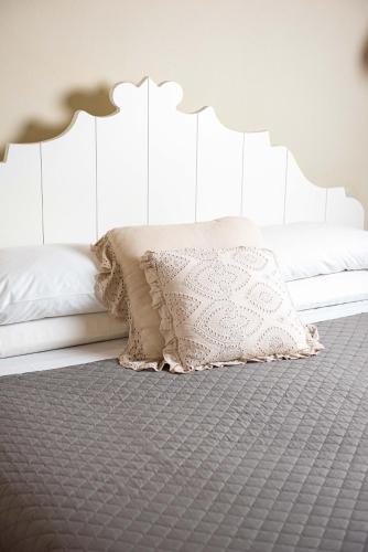 a bedroom with a bed with a white headboard at Nikis Resort in Gubbio