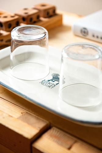a glass jar on a plate on a table at Nikis Resort in Gubbio