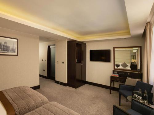a hotel room with a bed and a television at Montcalm Brewery, London City in London