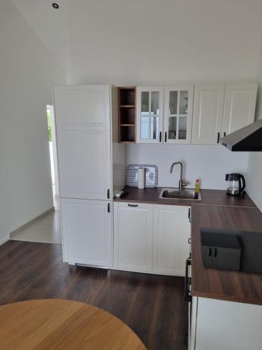 a white kitchen with a sink and a refrigerator at Villa Mila in Bol