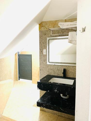 a bathroom with a black sink and a mirror at Sea Night - Sea Home Hotel in Phan Thiet