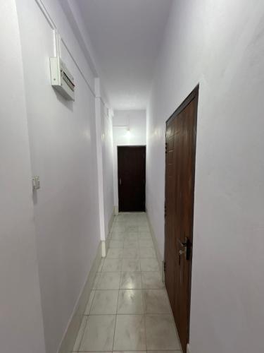 an empty hallway with a door and a hallwayngthngthngthngthngthngthngth at Raj Andar Guest House in Agartala