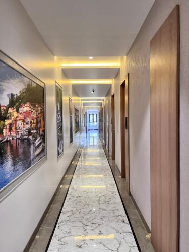 a hallway with paintings on the walls of a building at RED CARPET CLASSIC HOSPITALITY LLP in Māndvi