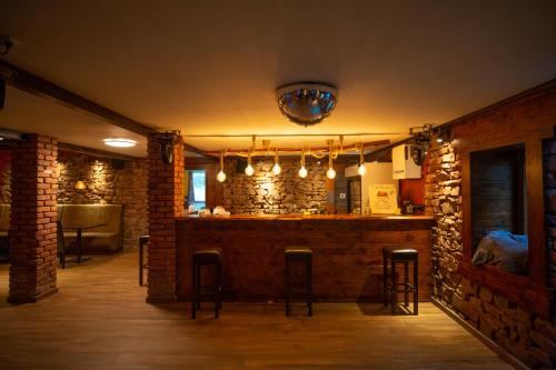 a bar in a restaurant with stools in a room at Landgut Girtenmühle in Britten