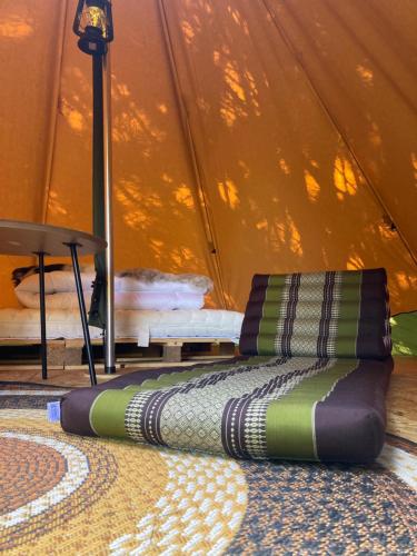 two pillows sitting on the floor in front of a tent at Kleine Tipi Texel in 't Horntje
