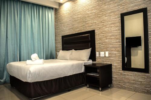 Postel nebo postele na pokoji v ubytování Bayside Hotel Pietermaritzburg