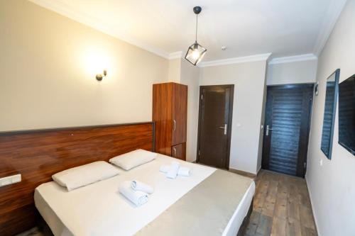 a bedroom with a bed with two white pillows at Marka Hotel in Antalya