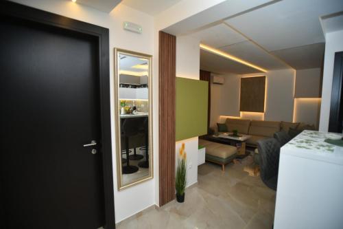 a room with a door and a living room at Apartman Viktor LUX in Kragujevac