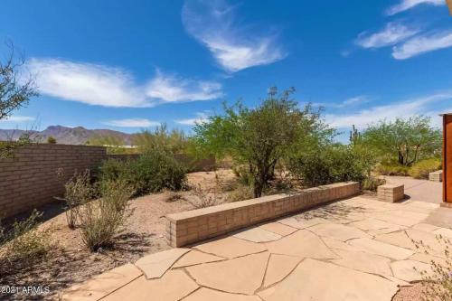 a brick retaining wall in the middle of a patio at Adventure and Serenity in Litchfield Park Sleeps 8 in Litchfield Park