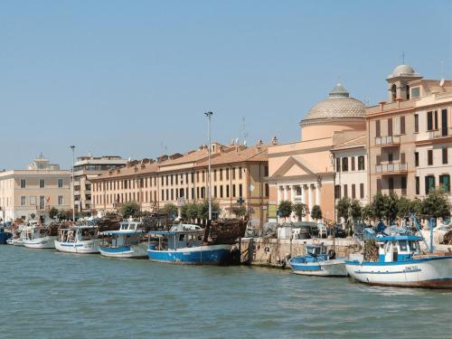 a group of boats docked in a harbor next to buildings at ROMA AIRPORT SKY Apartments in Fiumicino