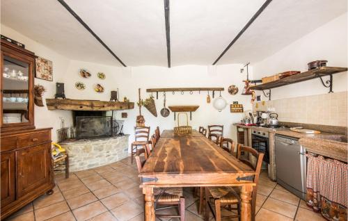 a kitchen with a wooden table and some chairs at Gorgeous Home In Capolona in Capolona
