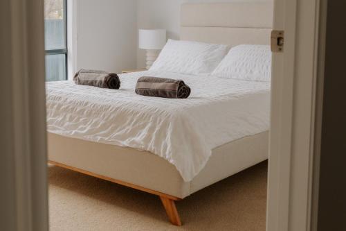 a bedroom with a bed with two pillows on it at Soulty Vibes in Coffin Bay
