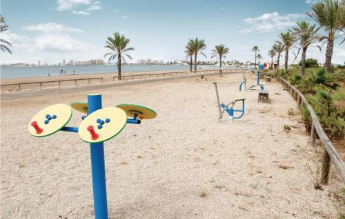 a playground on a beach with palm trees at Pet Friendly Home In Playa Honda in Playa Honda