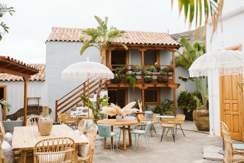 a patio with tables and chairs and a building at Dreamsea Boutique Experience in Moya