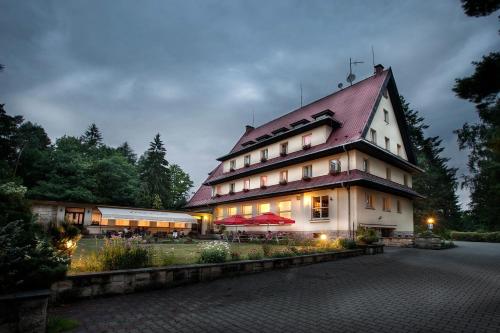 a large building with a red roof at Parkhotel Skalní město in Jičín
