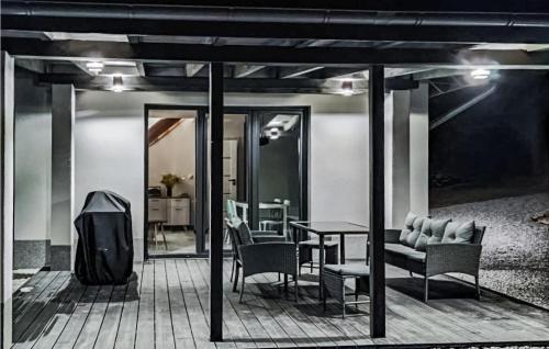 a patio with a table and chairs and a dining room at Amazing Home In Staniszów With Wifi in Staniszów