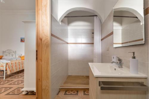 a bathroom with a sink and a shower at Villa Ketty by BarbarHouse in Andrano