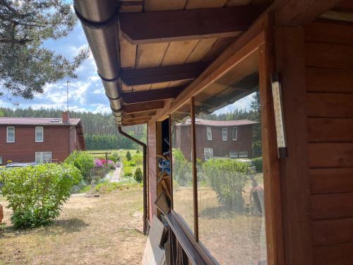 a window of a house with a view of a yard at Domek Staś in Wiele