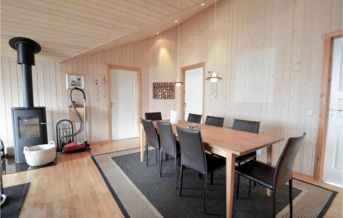 a dining room with a wooden table and chairs at Holiday Home Vinderup With Hot Tub X in Vinderup