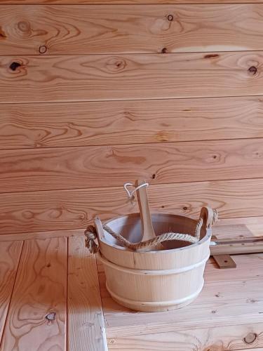 a metal bucket sitting on a wooden floor at Gite Mameye in Tellin