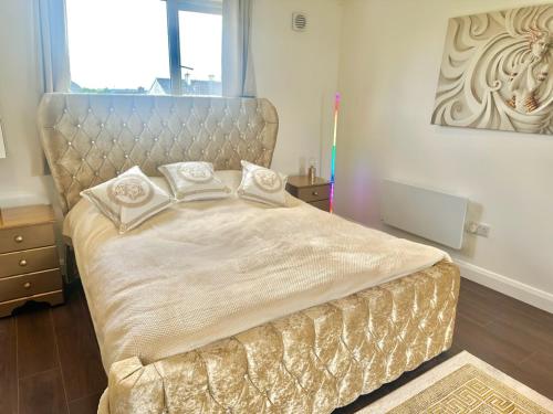 a bedroom with a large bed with a headboard at Kildare Luxury Suites in Kildare