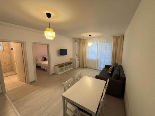 a living room with a couch and a table at Velvet Breeze Apartment in Năvodari
