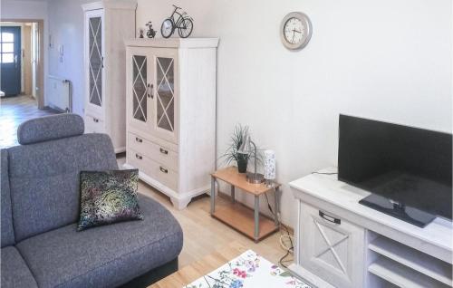 a living room with a couch and a flat screen tv at 1 Bedroom Nice Apartment In Barth in Barth