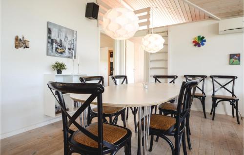 a dining room with a table and chairs at Holiday Home Hoelgårdvej in Kelstrup